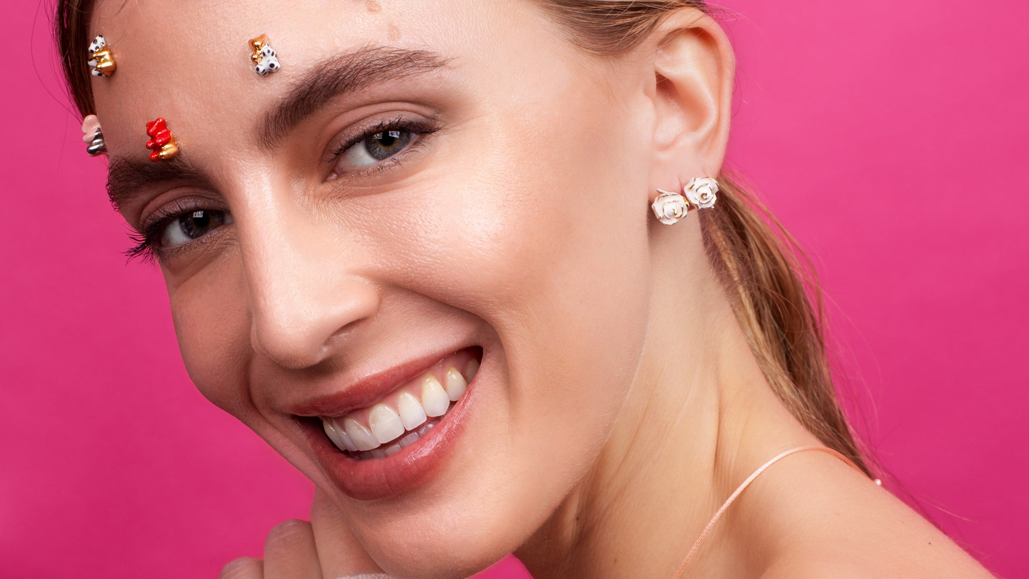 Tara wearing CJ314 rose earrings and gummy bear stud earrings